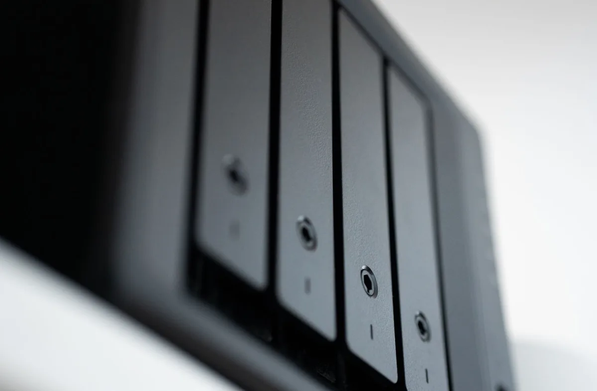 Close‑up of a modern external SSD plugged into a laptop, highlighting its sleek design.