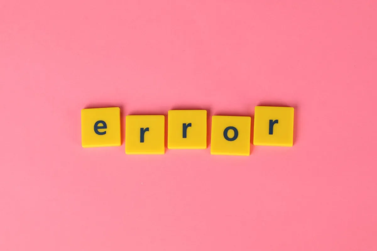 Yellow block letters spelling 'error' on a vibrant pink background, capturing a playful message.