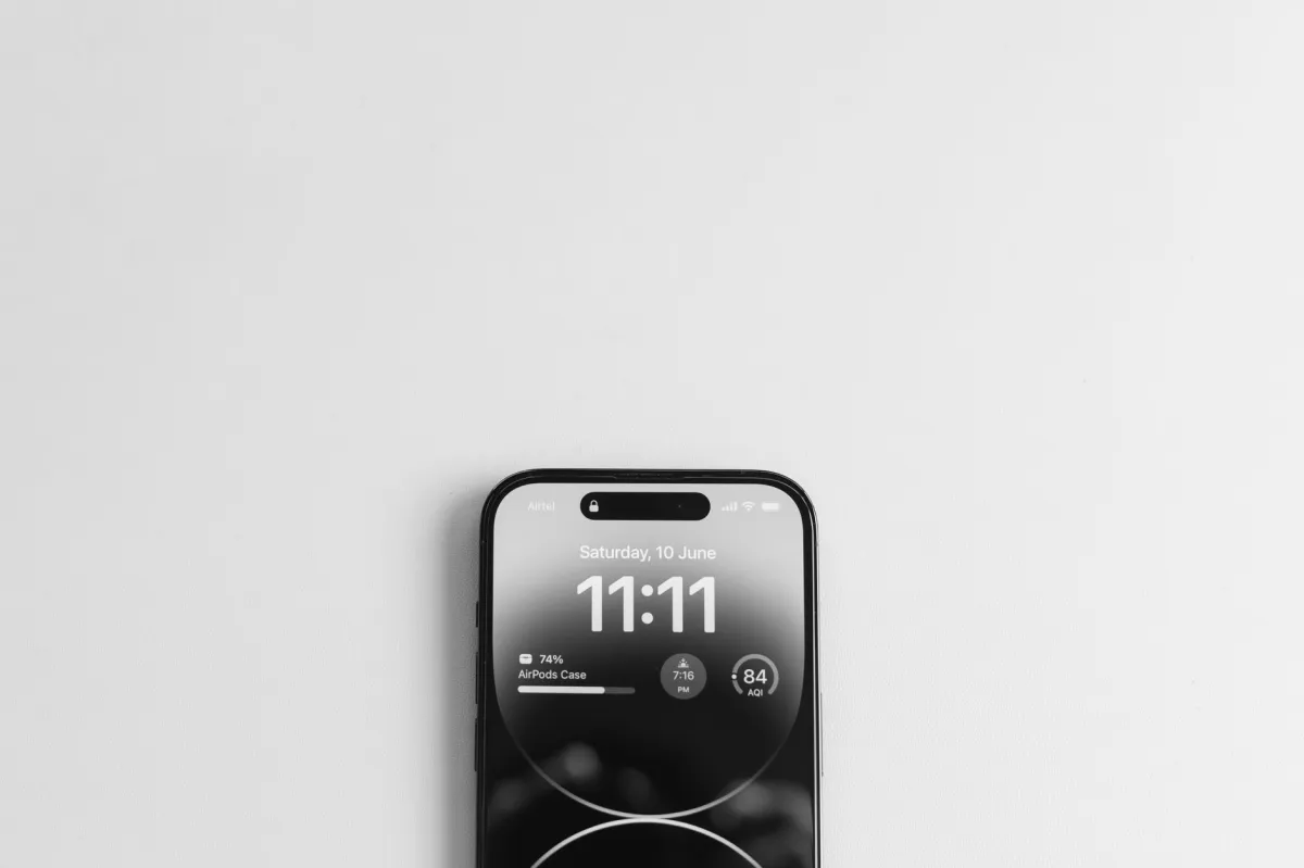 Top view of a smartphone displaying the time 11:11, on a minimalist white background.